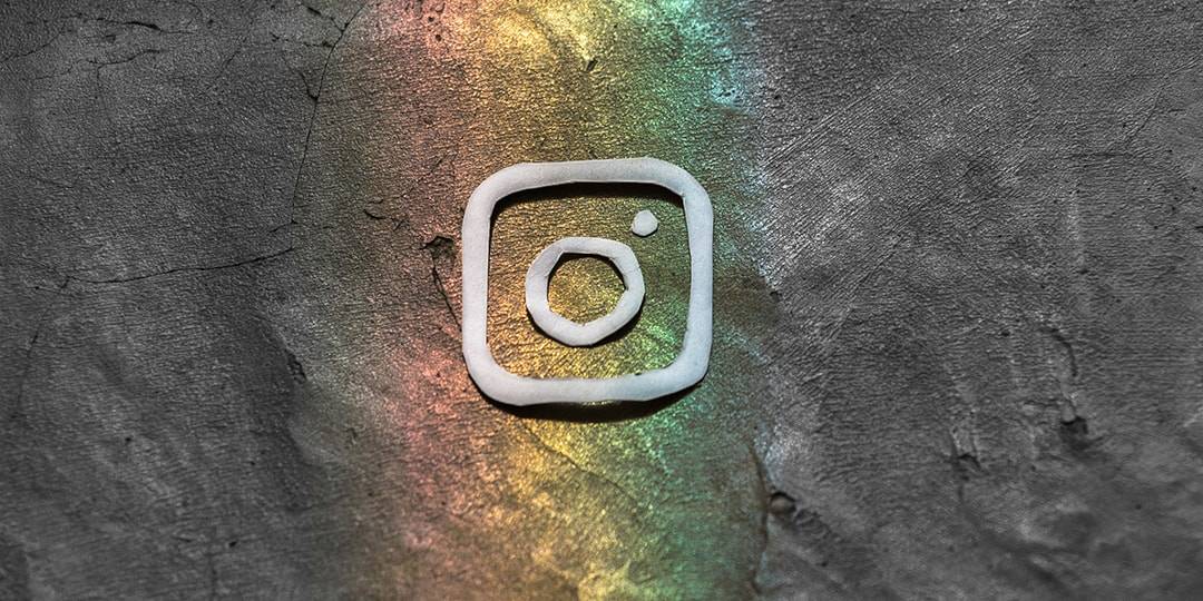 Instagram logo in rainbow on gray background