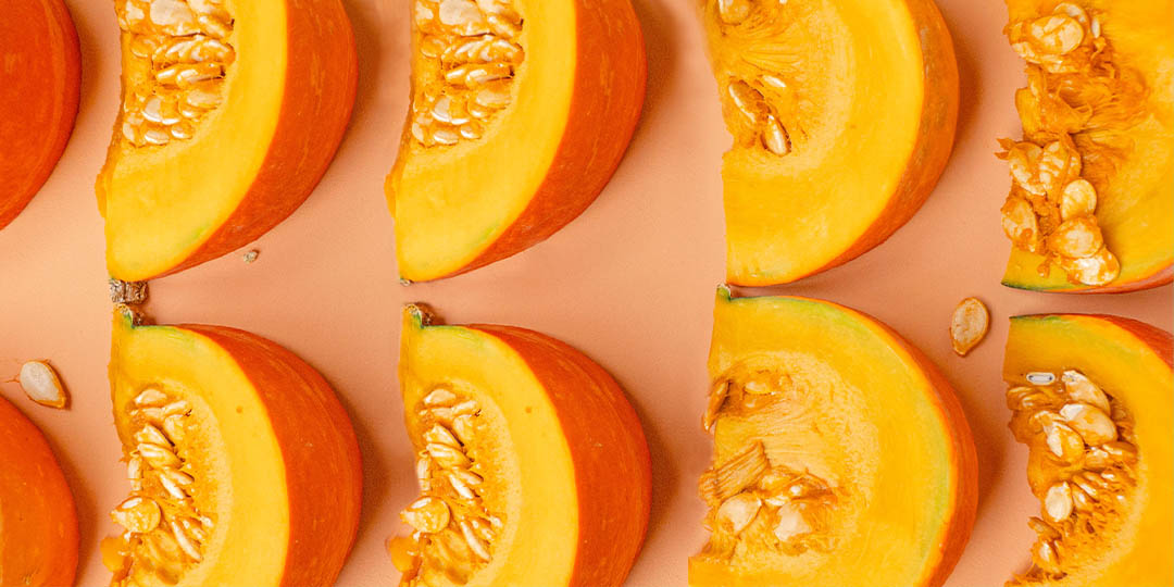 Pumpkin slices on orange background