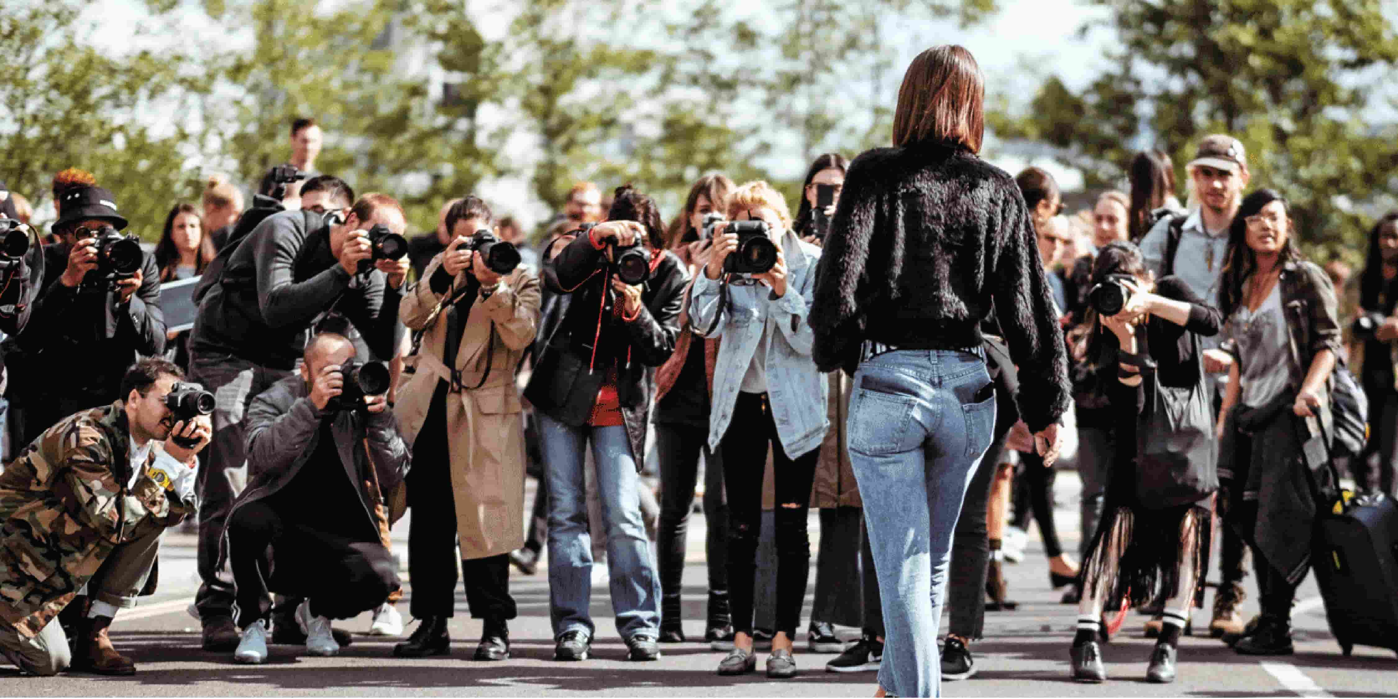 Woman influencer in front of photographers