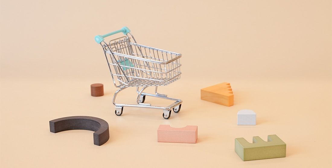 Empty shopping cart with products all around it 