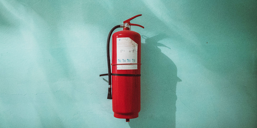 red fire extinguisher on blue background
