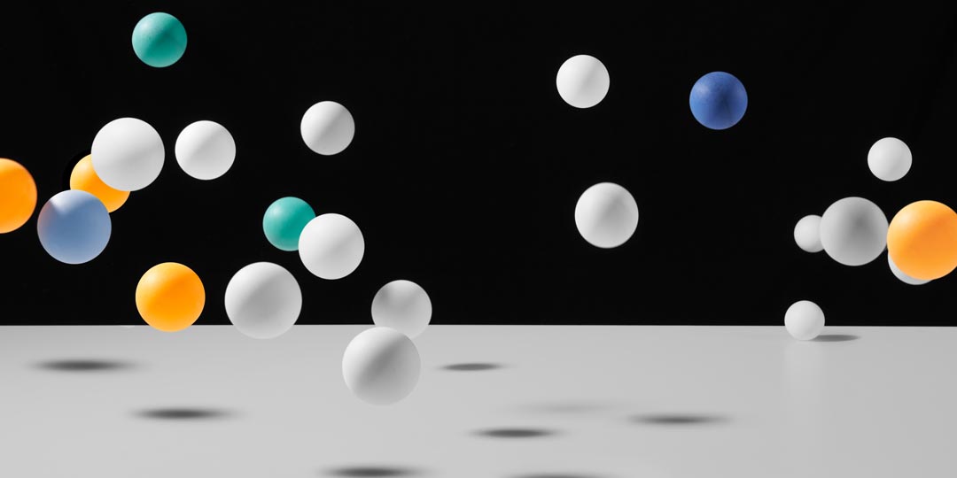 multicolored balls bouncing on black background