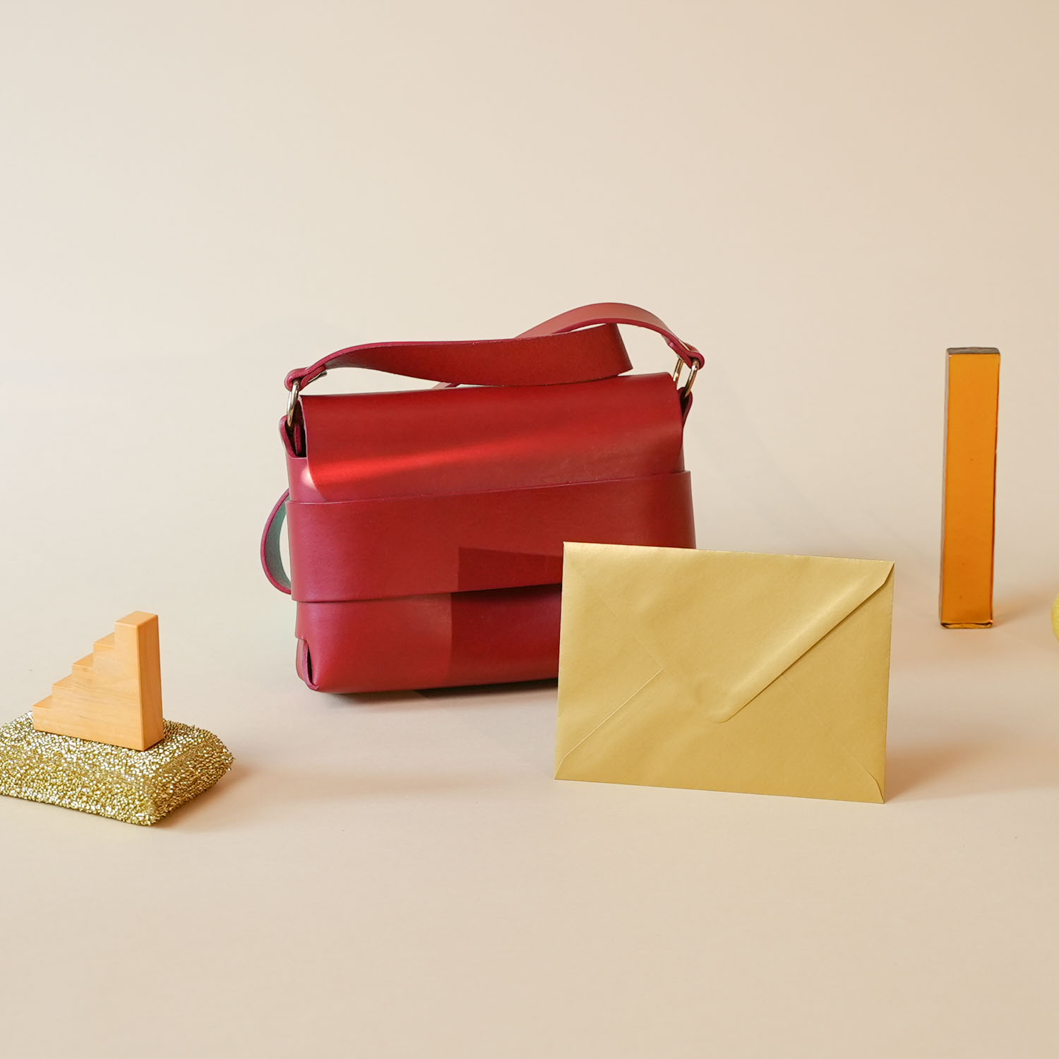 Bag with envelope on beige backdrop